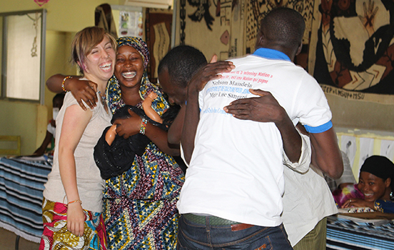 Students embracing local people in Tanzania